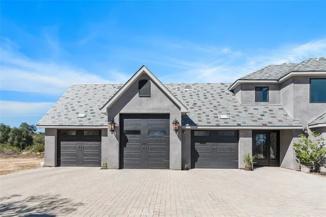 a front view of a house with yard and kitchen