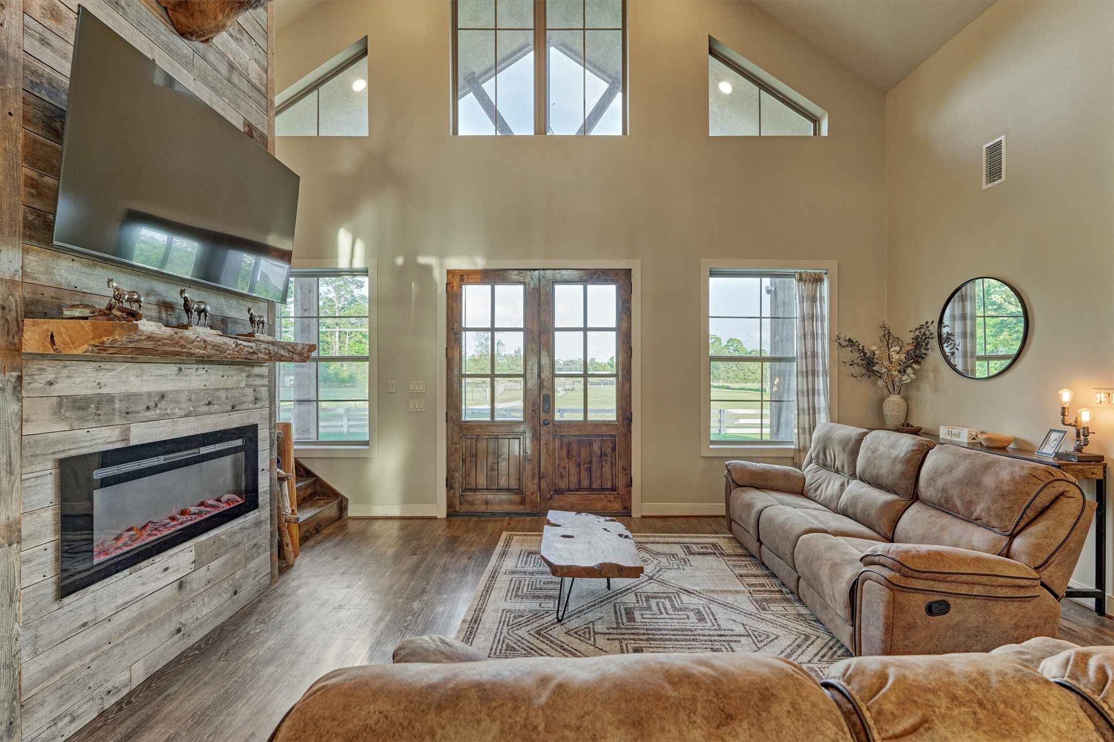 13125 Browder Traylor Road Willis, TX 77378 - Photo 13 of 50 a living room with furniture a fireplace a rug and a large window