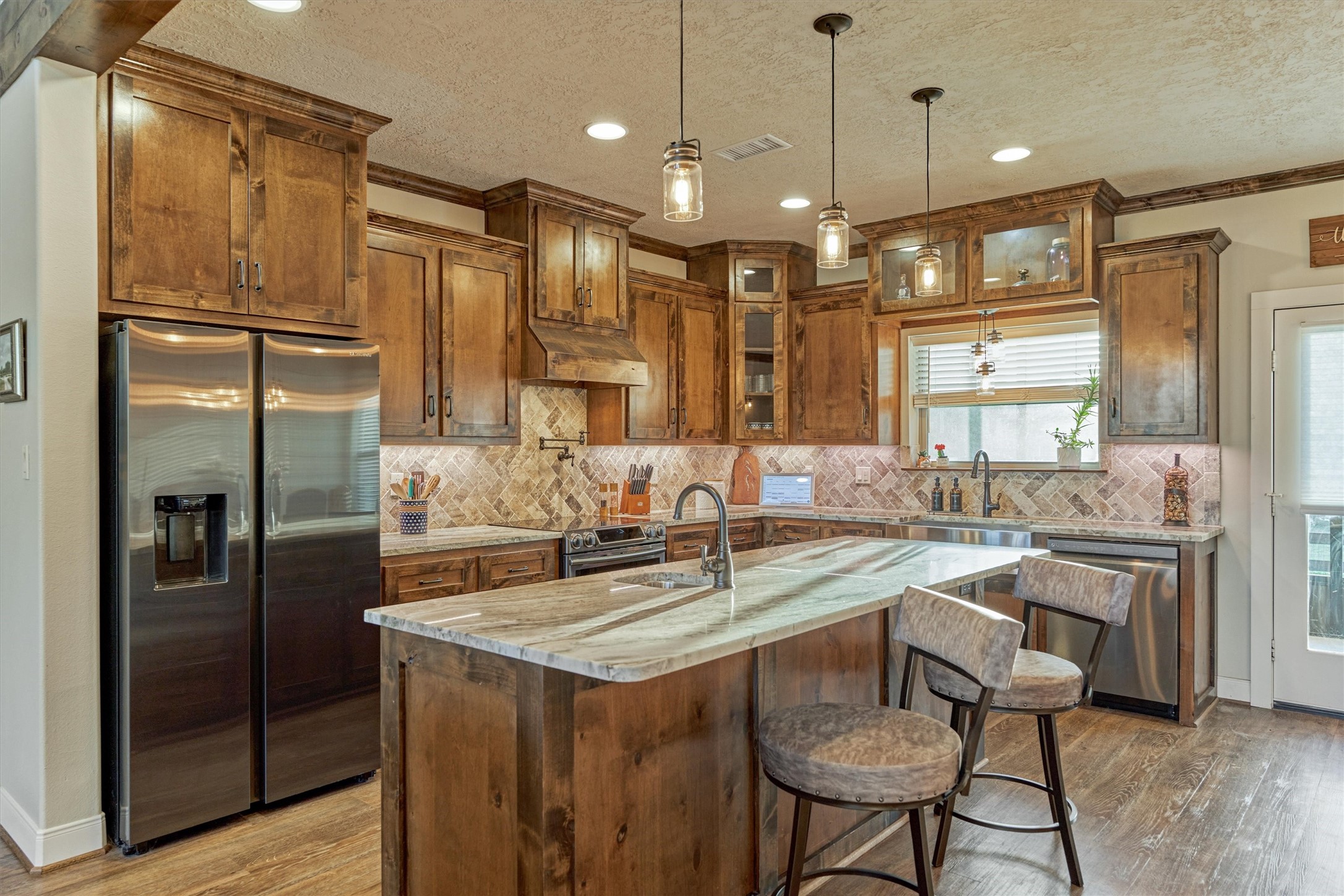 13125 Browder Traylor Road Willis, TX 77378 - Photo 18 of 50 a kitchen with center island and stainless steel appliances