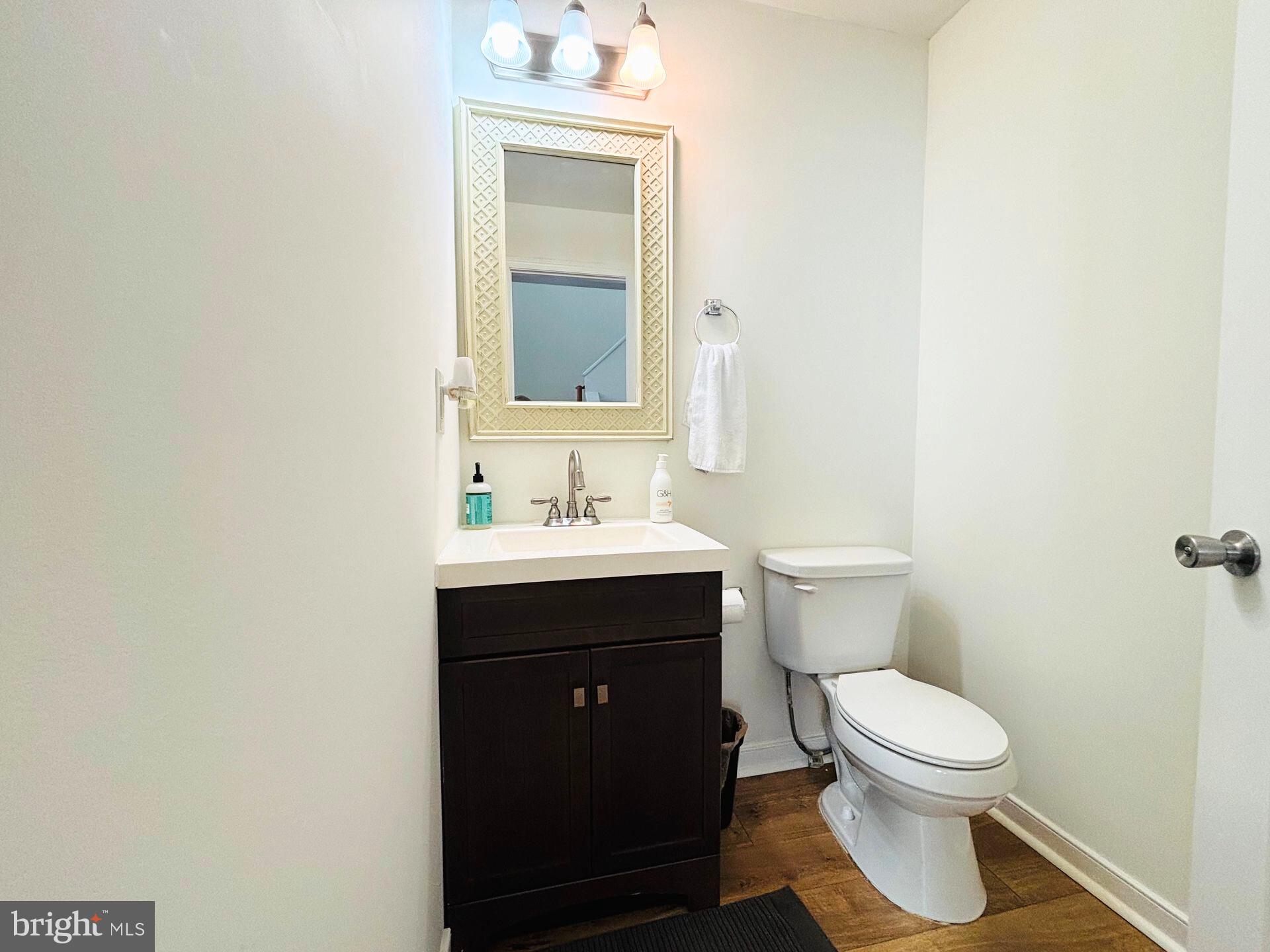 273 4th Avenue, Unit 101 Quantico, VA 22134 - Photo 11 of 36 a bathroom with a toilet a sink and mirror