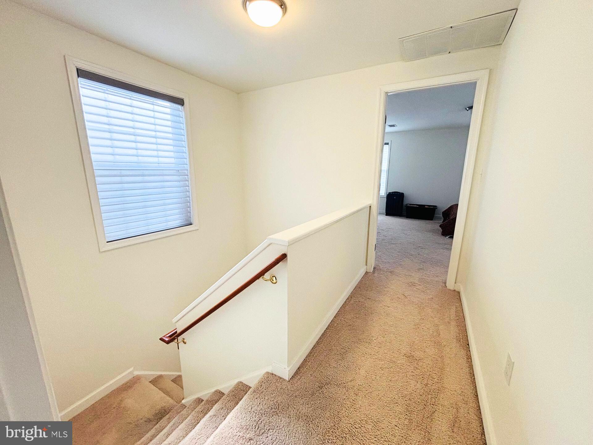273 4th Avenue, Unit 101 Quantico, VA 22134 - Photo 22 of 36 a view of a hallway with wooden floor and staircase