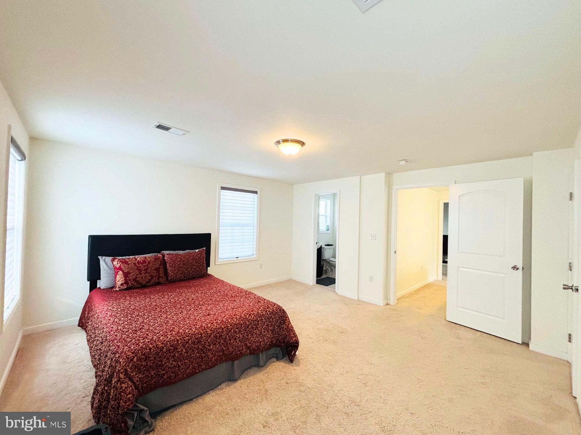 273 4th Avenue, Unit 101 Quantico, VA 22134 - Photo 24 of 36 a bedroom with a large bed and a chandelier