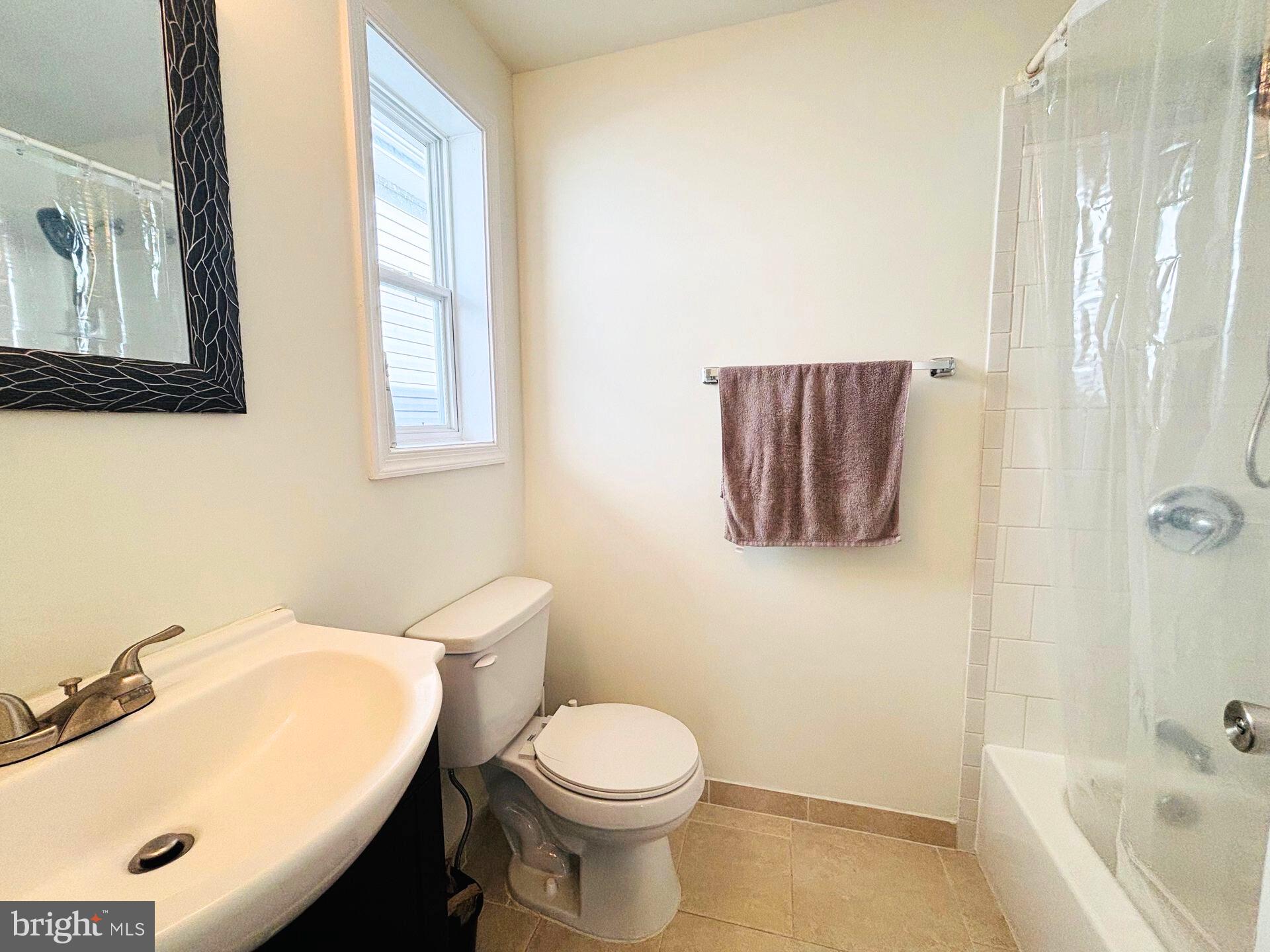 273 4th Avenue, Unit 101 Quantico, VA 22134 - Photo 28 of 36 a bathroom with a sink a toilet and shower