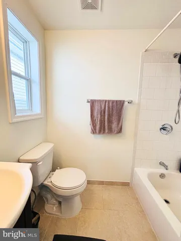 a bathroom with a toilet a sink and bathtub