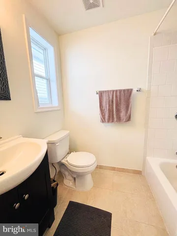 a bathroom with a sink a toilet and bathtub