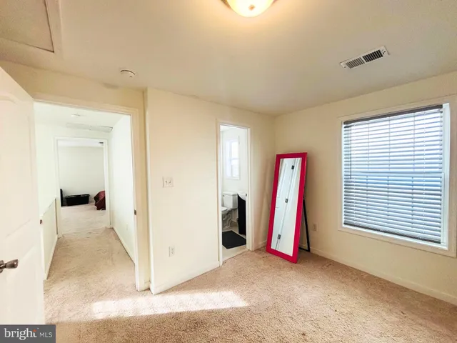 a view of a room with furniture and a window