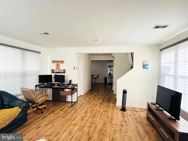 a view of a workspace with furniture and a window