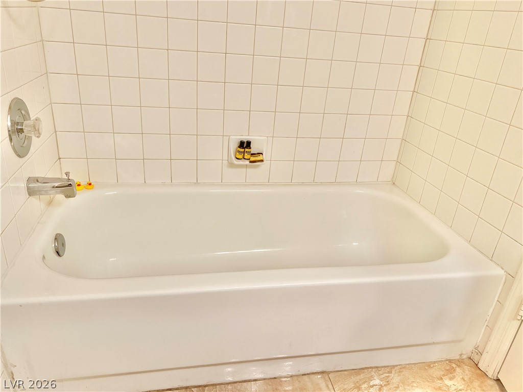 9708 Ridge Creek Place Las Vegas, NV 89134 - Photo 18 of 34 White subway tiles elegantly surround a classic soaking tub.