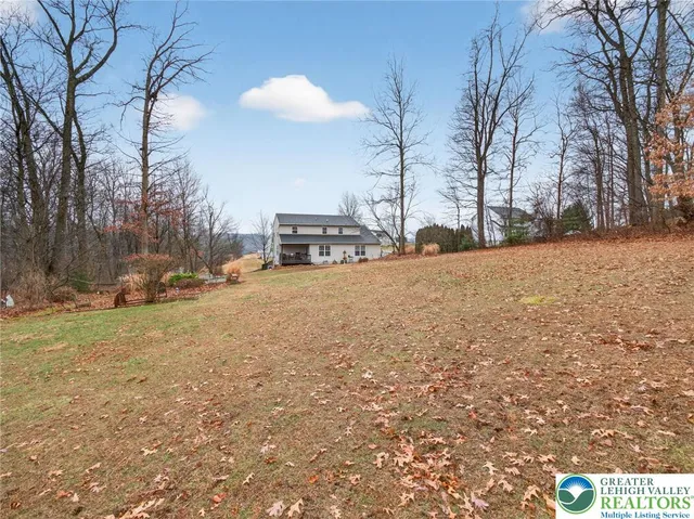 a view of a house with a yard and garage