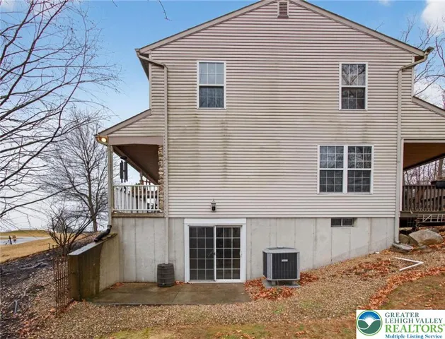 a patio with wooden cabinets and roof