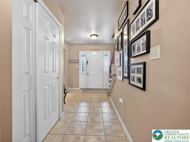 a living room with furniture and a dining table with wooden floor