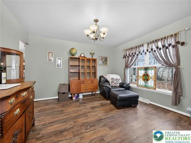 a living room with furniture and dresser