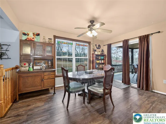 a dining room with furniture and wooden floor