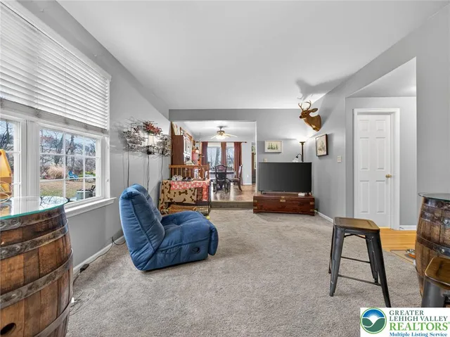 a view of a livingroom with furniture and a flat screen tv