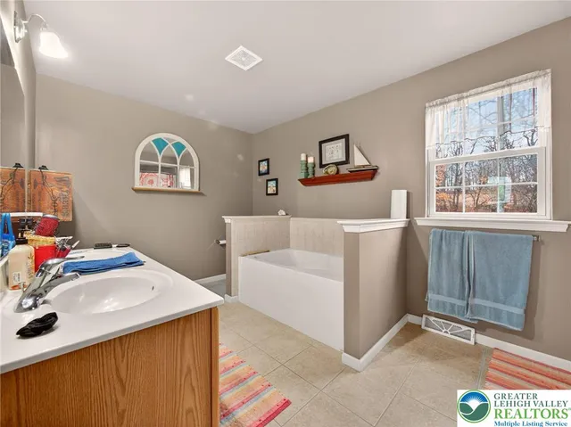 a hallway with a sink and a mirror