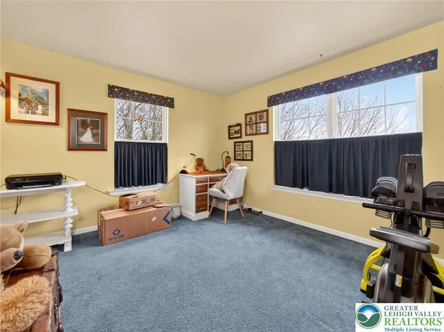 a bedroom with furniture and a lamp