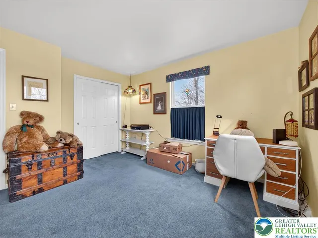 a bedroom with a bed couch and a window