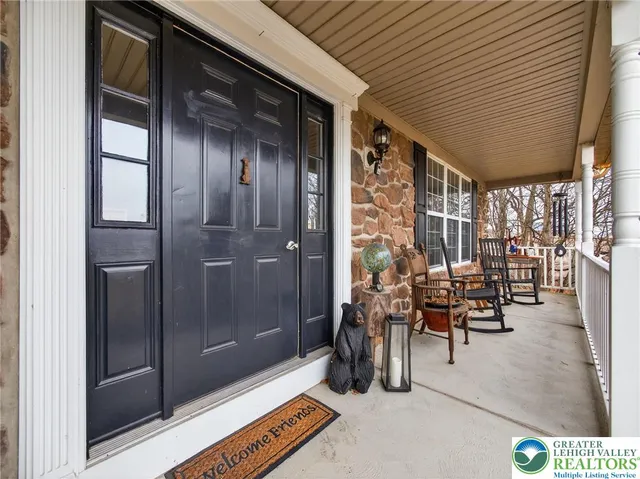 a view of a house with a yard covered in snow