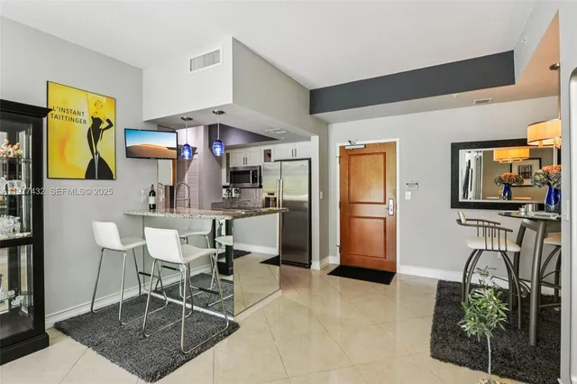 a kitchen with stainless steel appliances granite countertop a sink and a stove