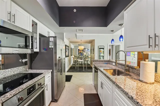 a bedroom with a bed and a dresser next to a window