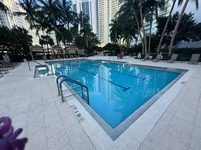 a view of a swimming pool with outdoor seating
