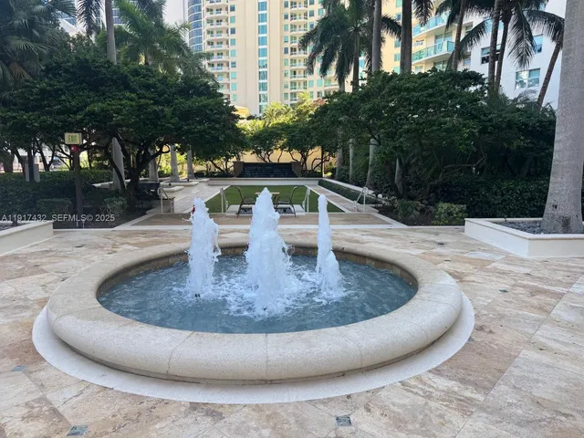 a patio with a table and chairs under an umbrella