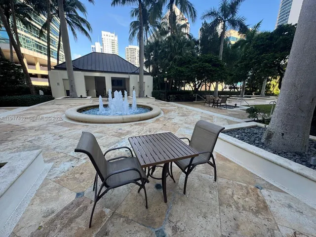 a view of a patio with a table and chairs