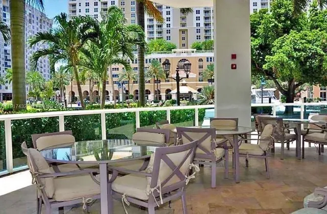a dining hall with a dining table and chairs with wooden floor