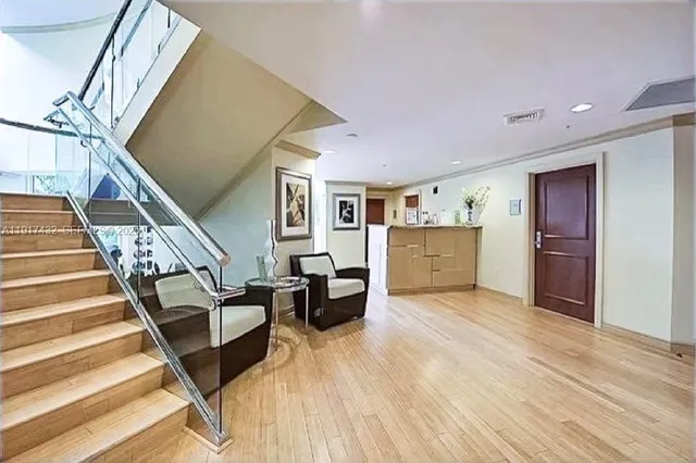 a dining room with furniture window and wooden floor