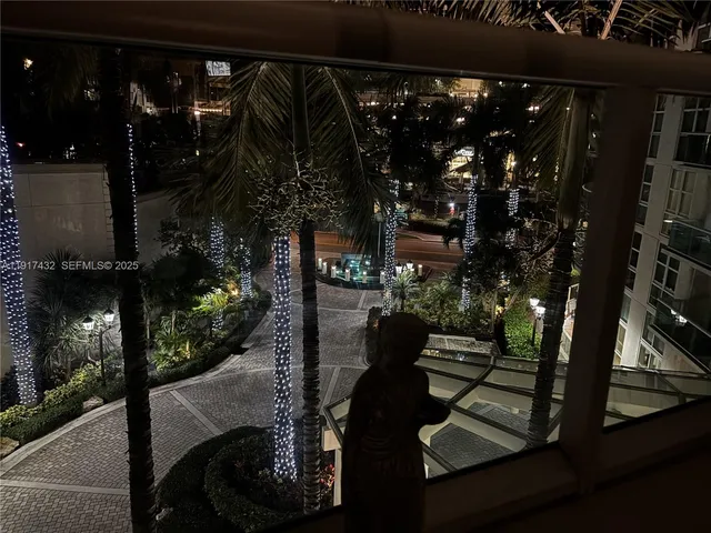 a living room with furniture a window and a flat screen tv