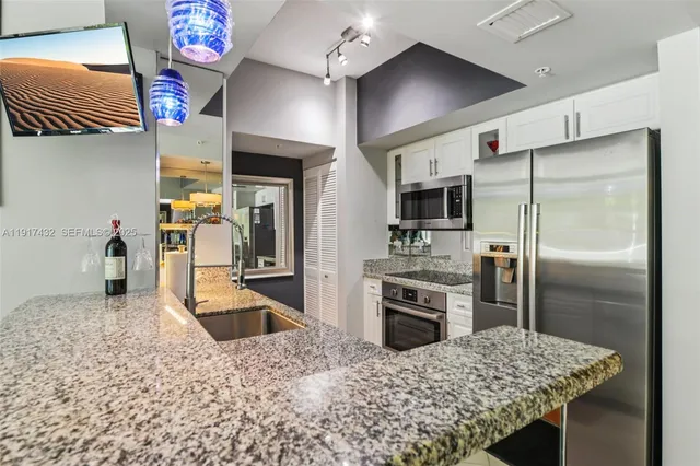 a dining room with furniture and a flat screen tv