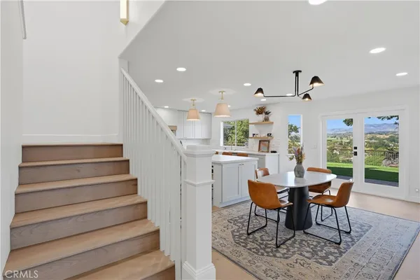 a dining room with furniture and wooden floor