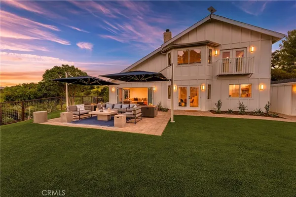 a backyard of a house with table and chairs