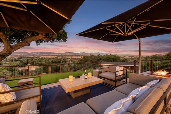 a view of a terrace with couches and pool
