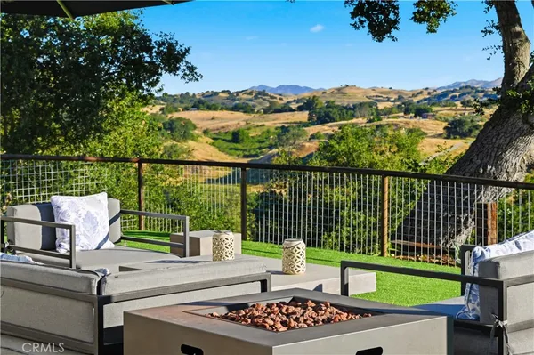 a view of a chairs and table in the back yard
