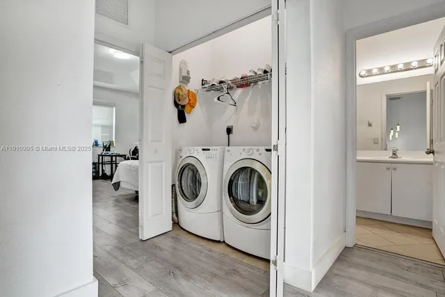 a view of a hallway with washer and dryer