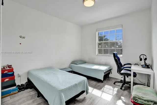 a bedroom with furniture and a window