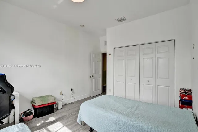 a bedroom with a bed and a couch