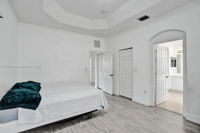 a bedroom with a bed and a mirror