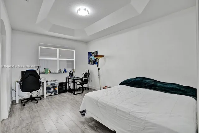 a bedroom with a bed a table and a window