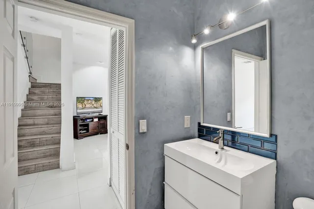 a bathroom with a sink and mirror