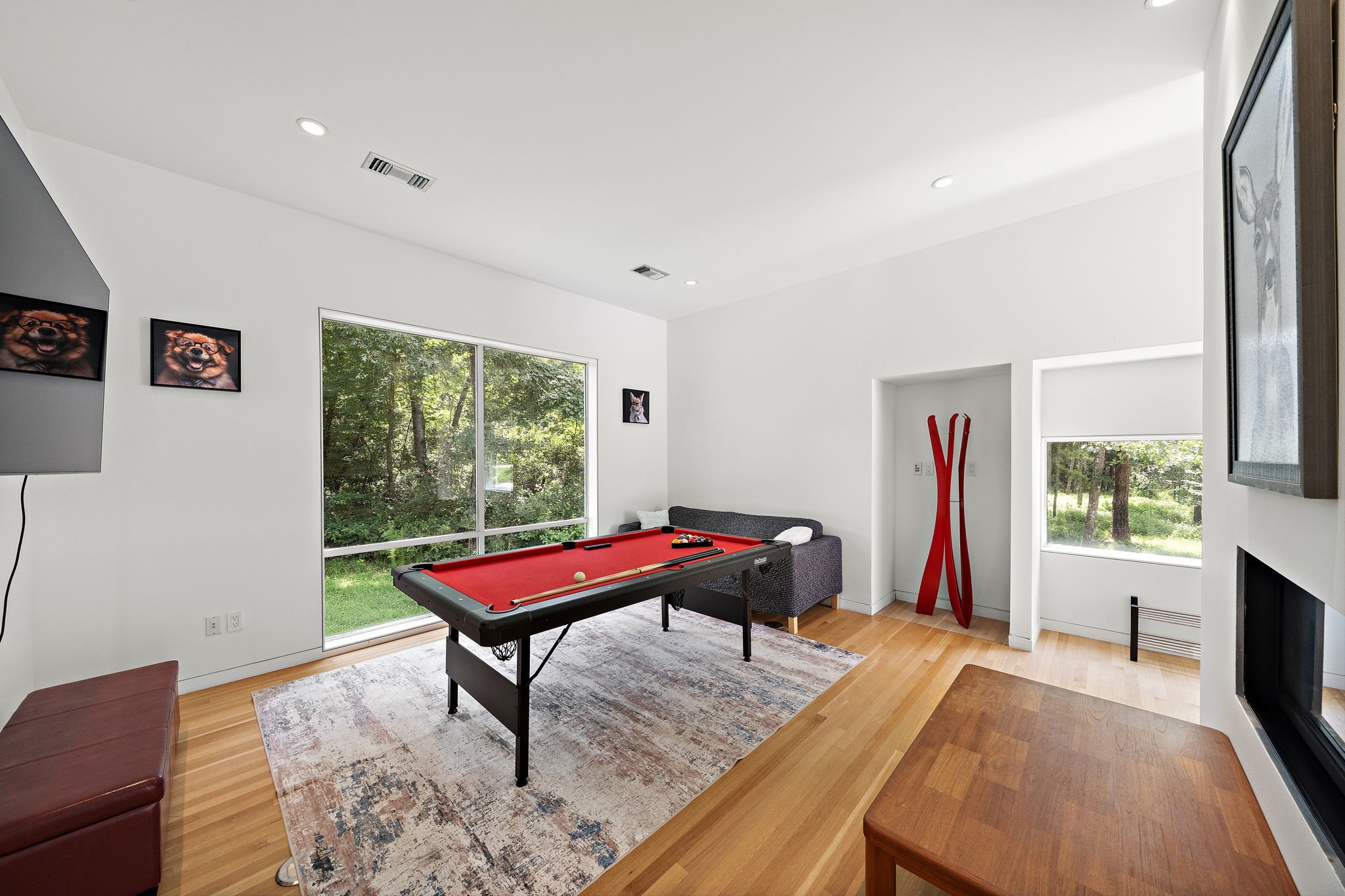 118 Angel Leaf Road Spring, TX 77380 - Photo 12 of 50 Versatile game room with scenic wooded views, modern furnishings, and plenty of natural light — perfect for relaxing or entertaining.
