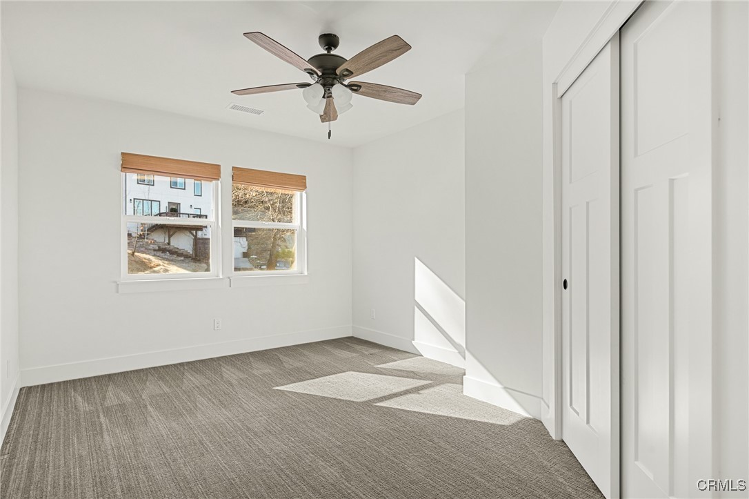 26880 Abner Drive Lake Arrowhead, CA 92352 - Photo 22 of 36 a view of empty room with wooden floor and fan