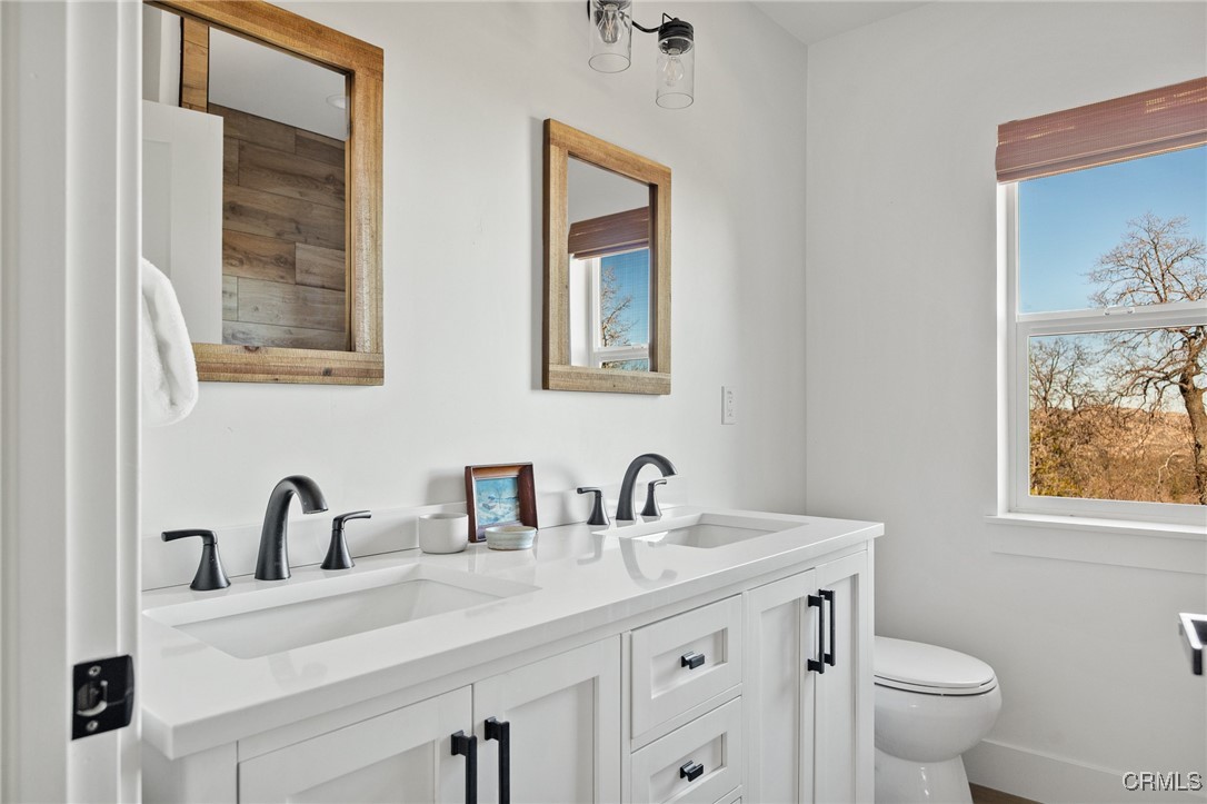 26880 Abner Drive Lake Arrowhead, CA 92352 - Photo 24 of 36 a bathroom with a toilet sink and mirror