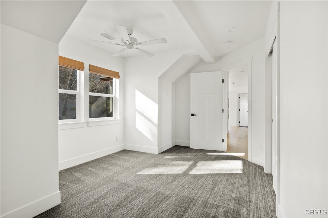 26880 Abner Drive Lake Arrowhead, CA 92352 - Photo 26 of 36 an empty room with wooden floor fan and windows