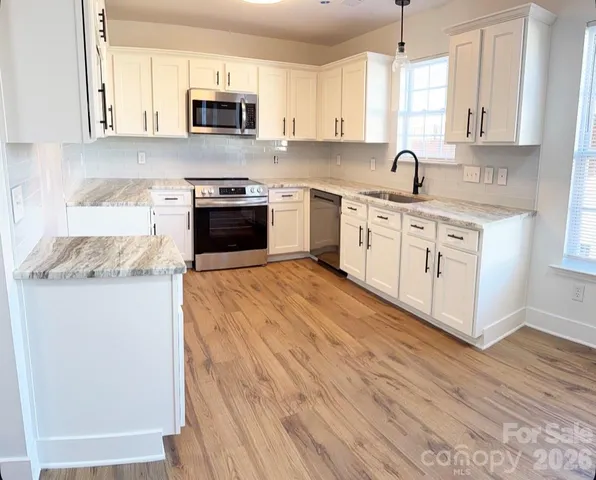 a view of a kitchen with wooden floor