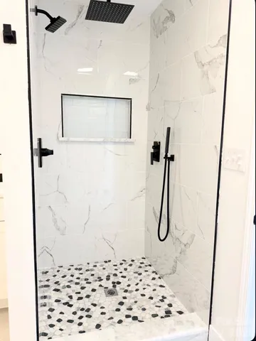 a bathroom with a tub sink and granite