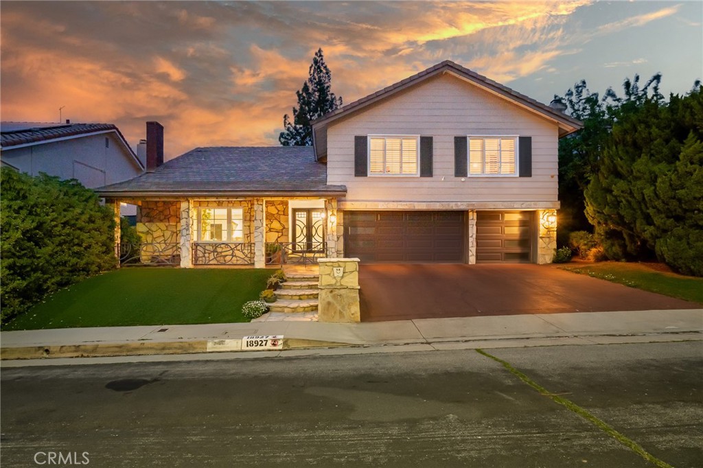 18927 Granada Circle Porter Ranch, CA 91326 - Photo 1 of 75 a front view of a house with a yard and garage