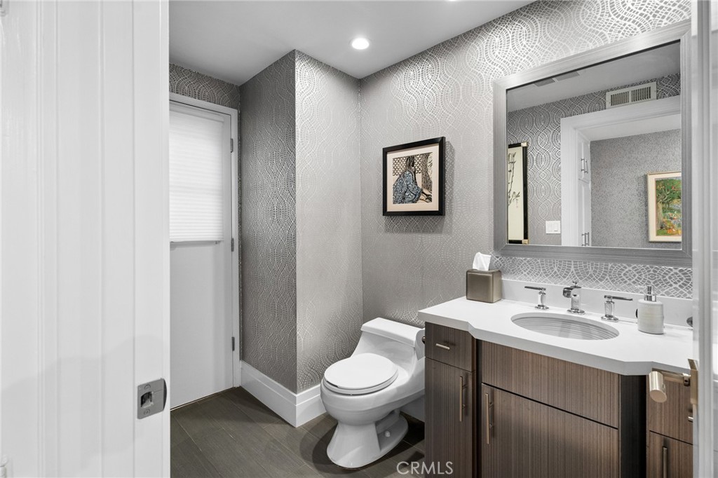 18927 Granada Circle Porter Ranch, CA 91326 - Photo 19 of 75 a bathroom with a toilet a sink a mirror and a shower