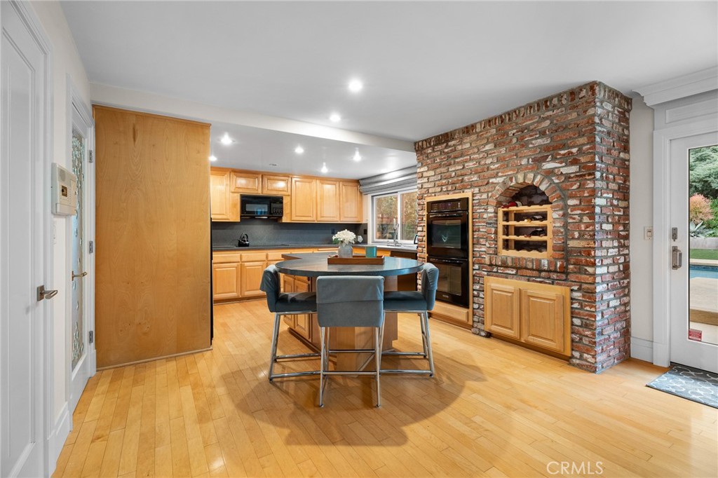 18927 Granada Circle Porter Ranch, CA 91326 - Photo 23 of 75 a kitchen with stainless steel appliances kitchen island granite countertop a table and chairs in it